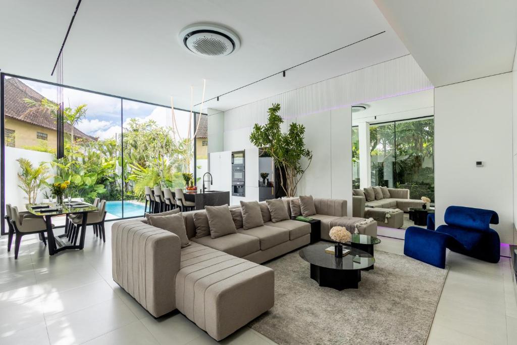 a living room with a couch and a table at Archestet Villas Canggu in Canggu