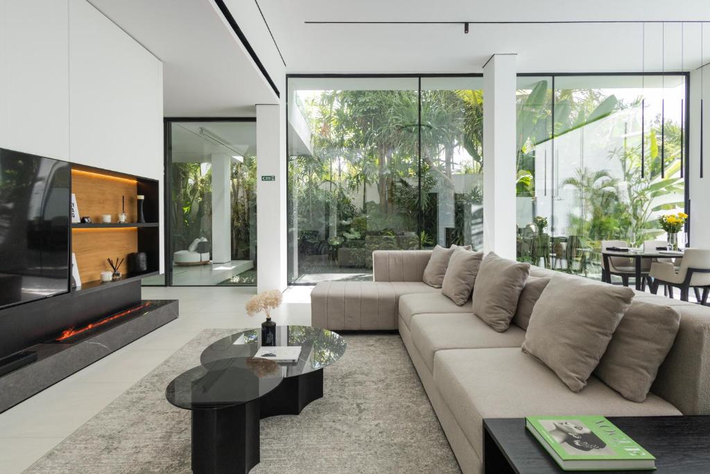 a living room with a couch and a tv at Archestet Villas Canggu in Canggu
