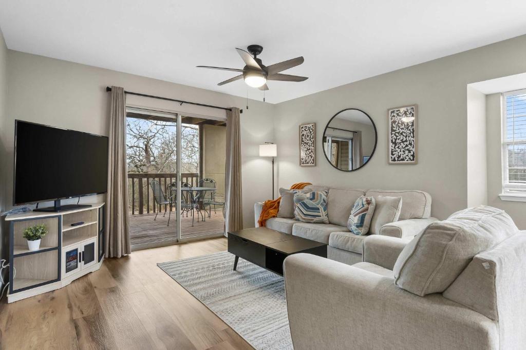a living room with a couch and a flat screen tv at Modern Comfort Retreat in Branson