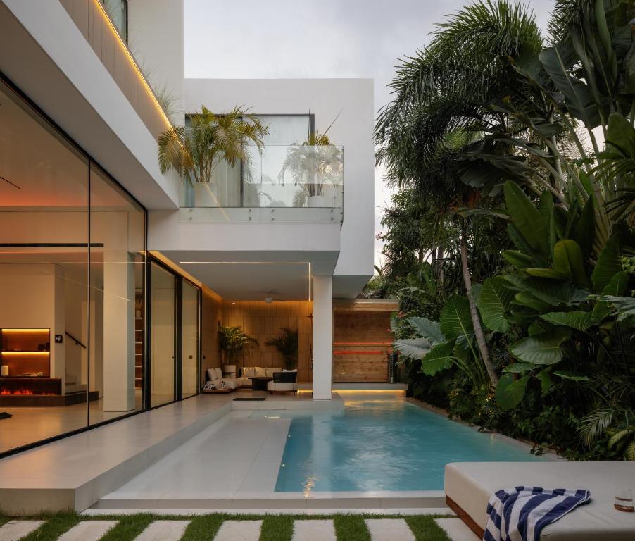 an indoor pool in a house with plants at Archestet Villas Canggu in Canggu