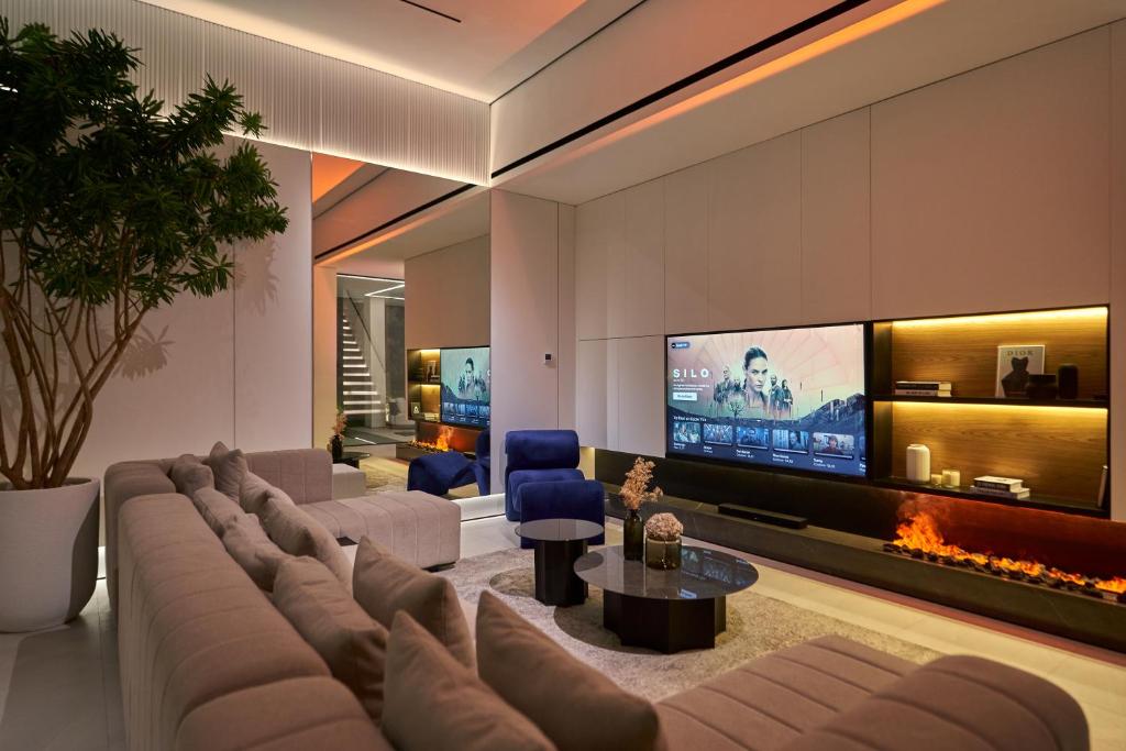 a living room with a couch and a tv at Archestet Villas Canggu in Canggu