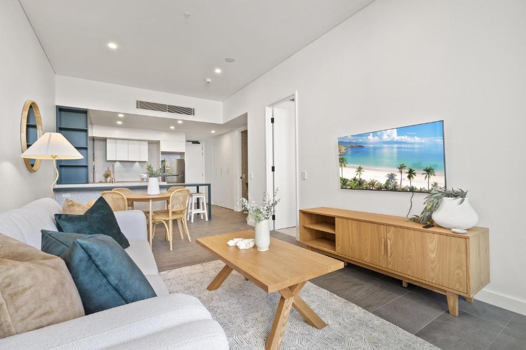 a living room with a couch and a table at Ground Floor Apartment with Private Courtyard in North Fremantle