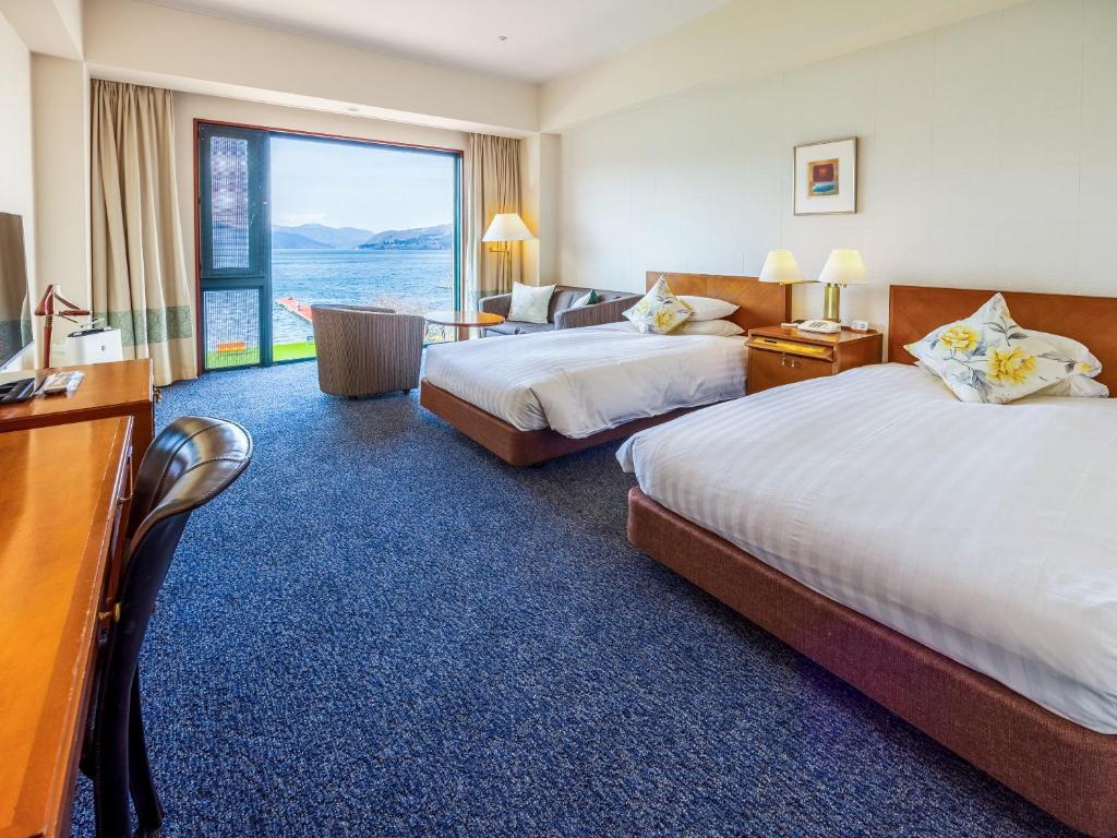 Postel nebo postele na pokoji v ubytování Hakone Hotel