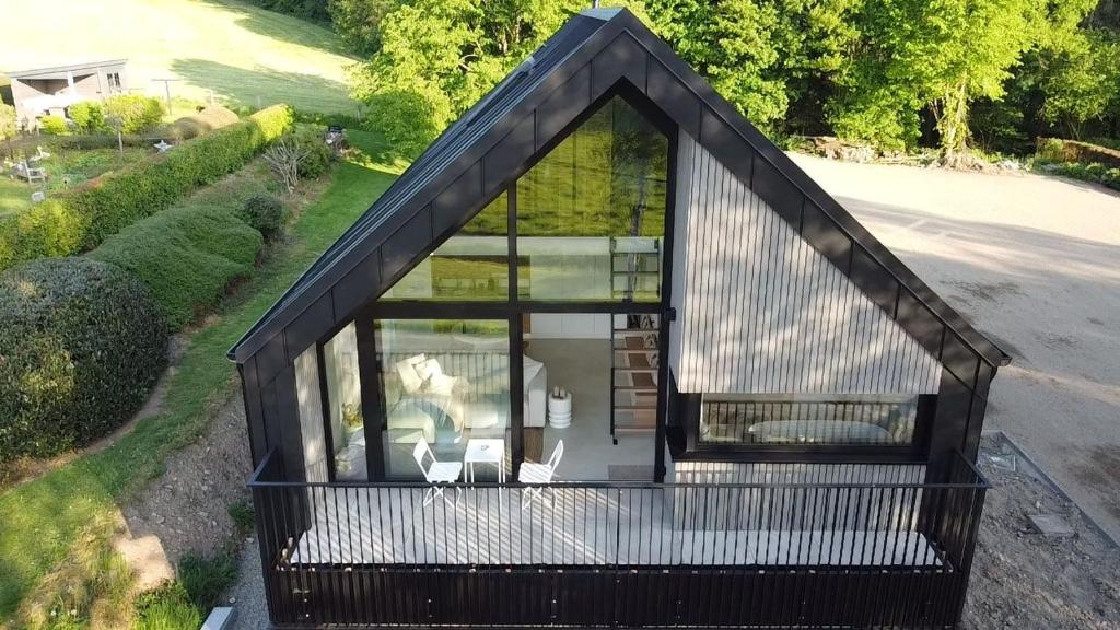 an overhead view of a small house with a large window at Toi-t et moi, Charming penthouse, view et nature in Malmedy