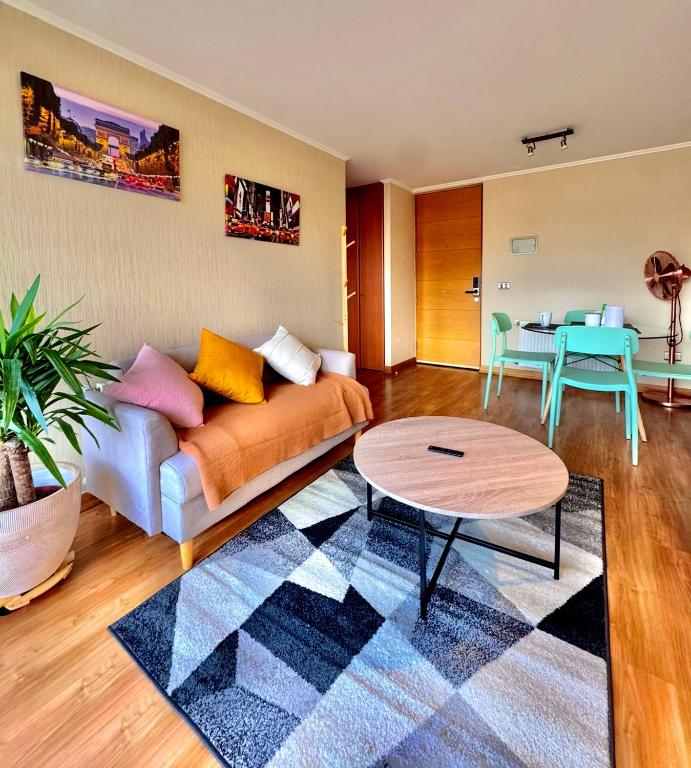 a living room with a couch and a table at Centro Temuco 4 in Temuco