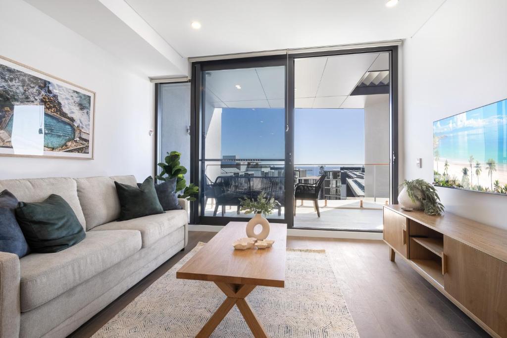 a living room with a couch and a table at Penthouse Stay With Ocean Views in North Fremantle