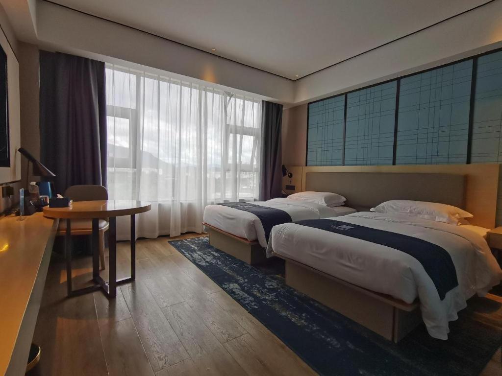Postel nebo postele na pokoji v ubytování Echarm Hotel Changjiang Shilu