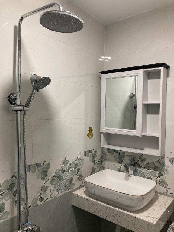 a bathroom with a sink and a shower at Jerry house - Private House in the City center in Hue