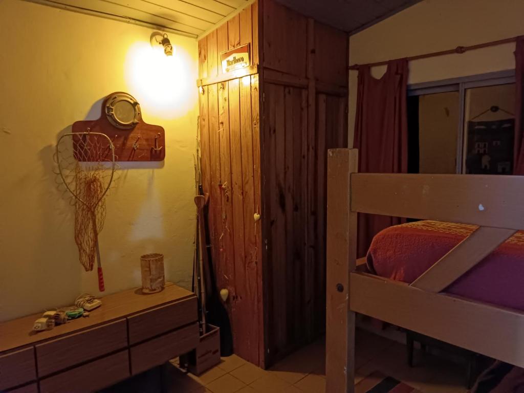 a bedroom with a bunk bed and a clock on the wall at Samadhi in Tigre
