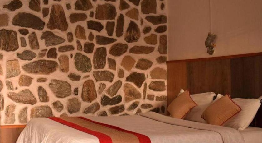 Postel nebo postele na pokoji v ubytování Stupa Resort