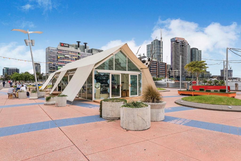a building with a triangular roof in a city at Docklands Private Collection - NEWQUAY in Melbourne