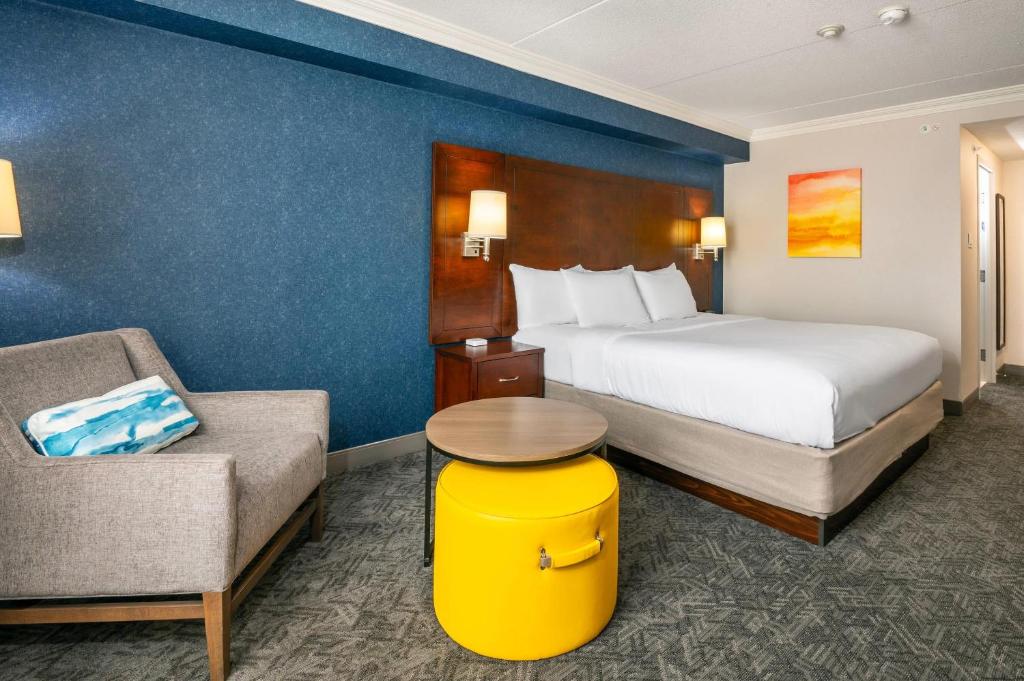 a hotel room with a bed and a chair at Comfort Inn & Conference Centre Toronto Airport in Toronto