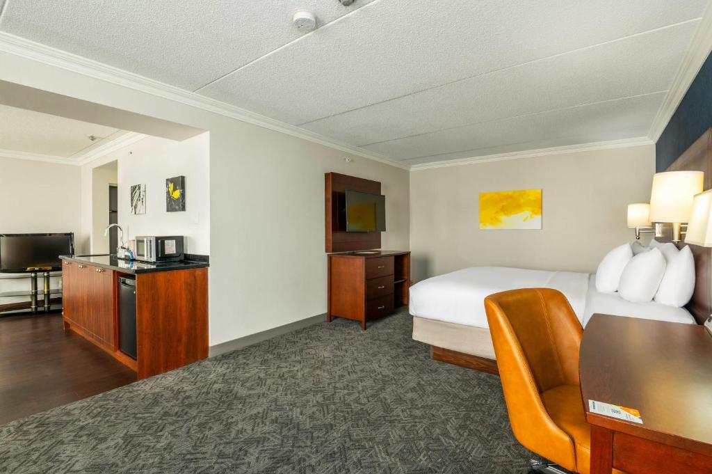 a hotel room with a bed and a television at Comfort Inn & Conference Centre Toronto Airport in Toronto