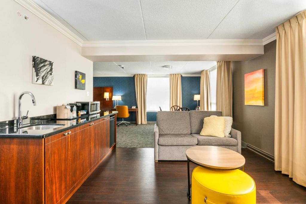 a kitchen and living room with a couch and a table at Comfort Inn & Conference Centre Toronto Airport in Toronto