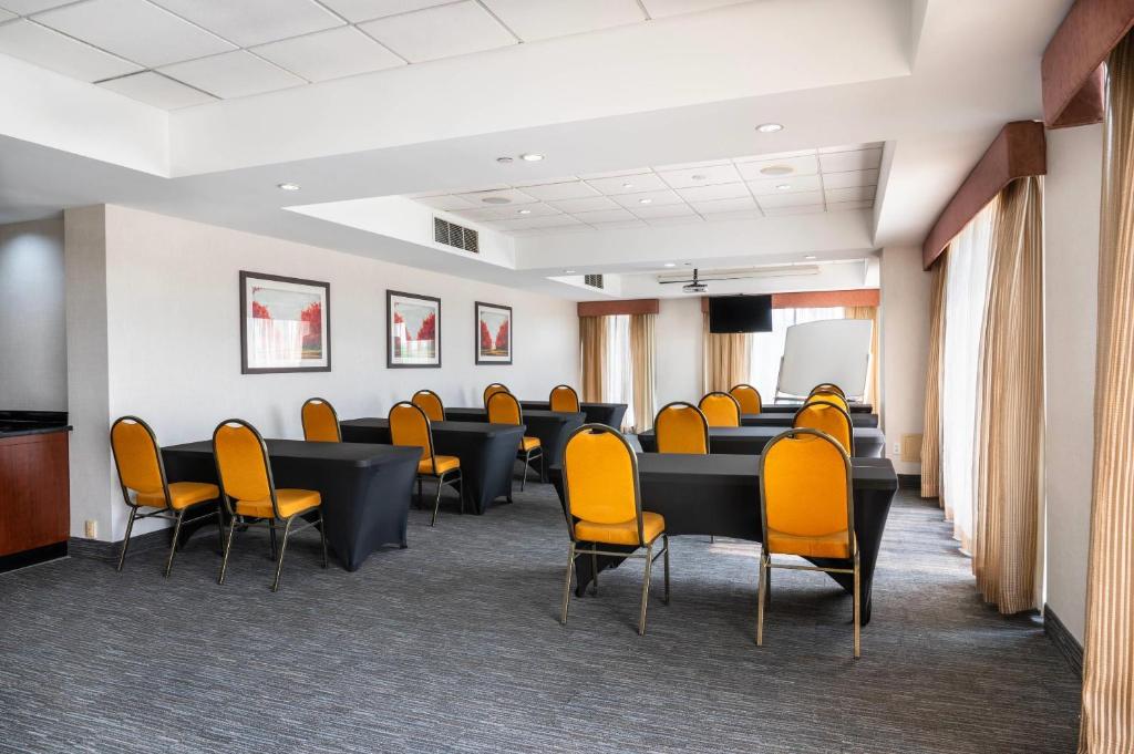 a conference room with chairs and tables and a podium at Comfort Inn & Conference Centre Toronto Airport in Toronto
