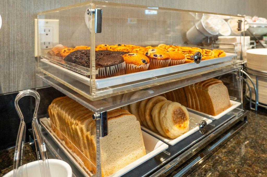 a display case filled with lots of different types of bread at Comfort Inn & Conference Centre Toronto Airport in Toronto