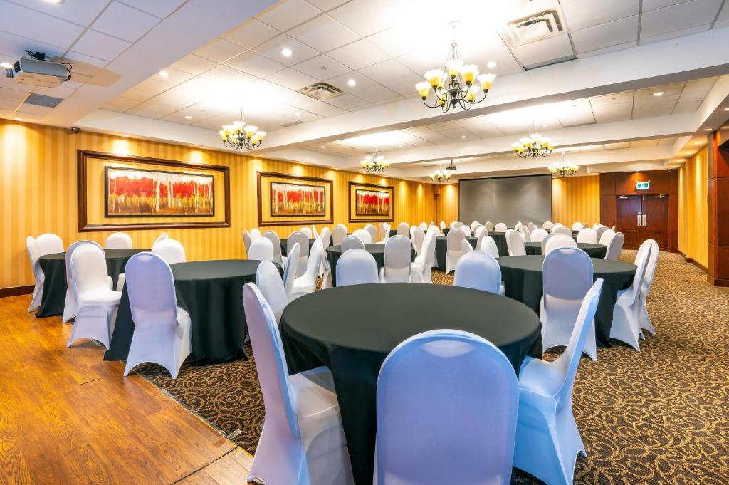 a conference room with black tables and white chairs at Comfort Inn & Conference Centre Toronto Airport in Toronto