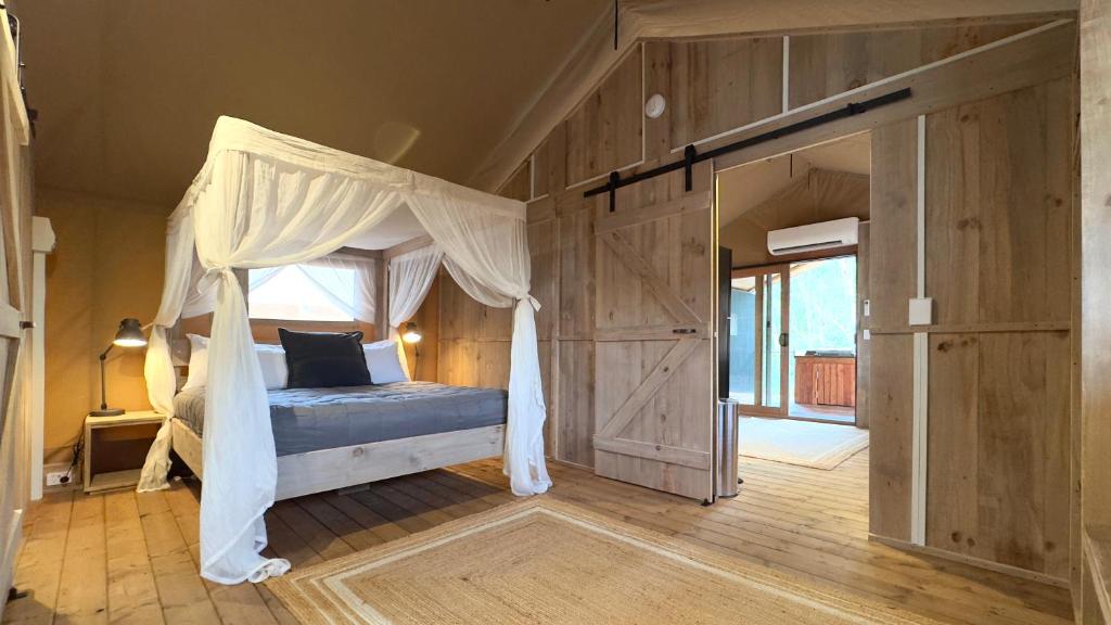 a bedroom with a bed with a canopy at BIG4 Yarra Valley Park Lane Holiday Park in Healesville