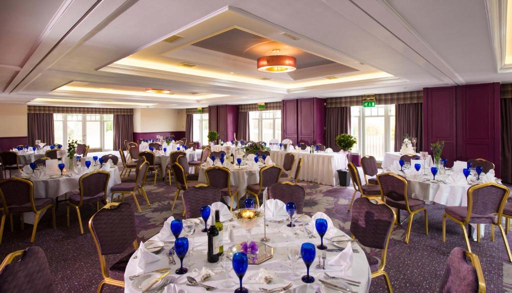 a banquet room with white tables and chairs at Leonardo Boutique Huntingtower Perth in Perth