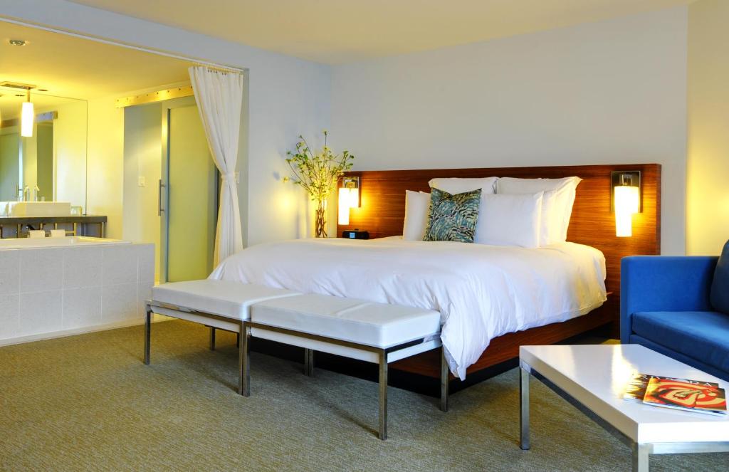 a bedroom with a large bed and a blue couch at Tower 23 Hotel in San Diego