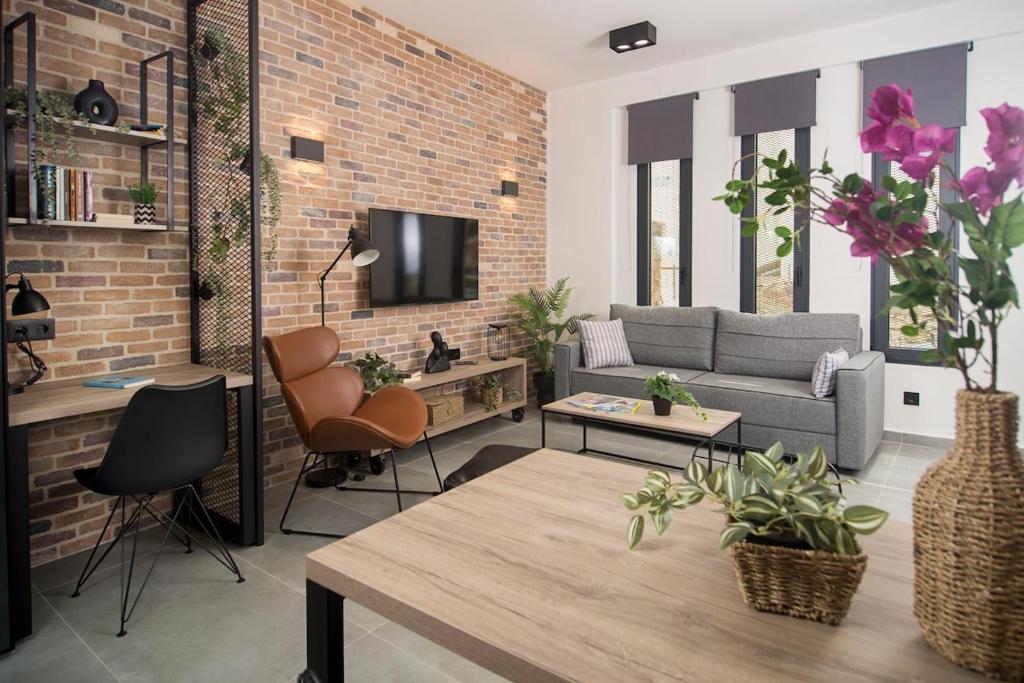 a living room with a couch and a tv at DG space 1A in Kalamata