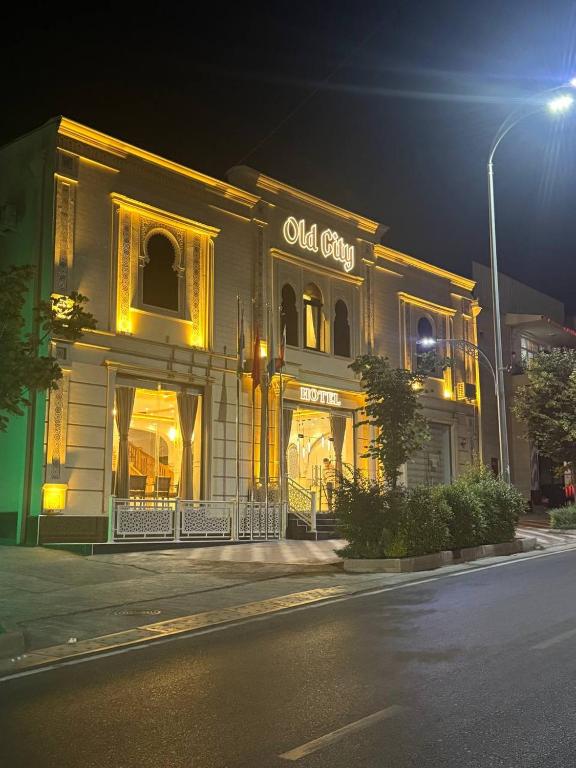 a building with an old city sign on the side of a street at Old City Samarkand Hotel in Samarkand