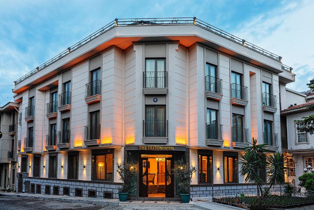 a white building with an orange trim at Triton Hotel in Istanbul