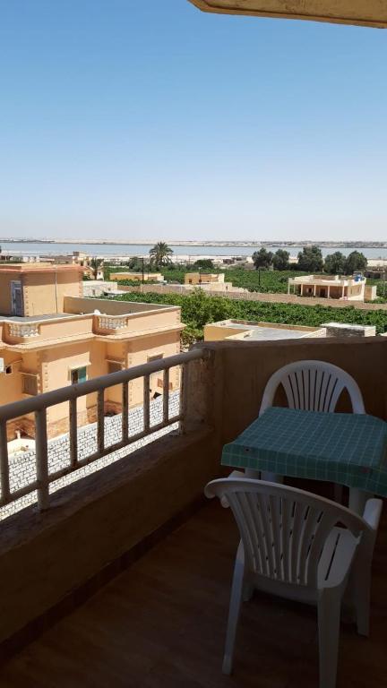 a balcony with a table and chairs and the beach at شاليه بقرية تاهيتي الساحل الشمالي in El Hamam