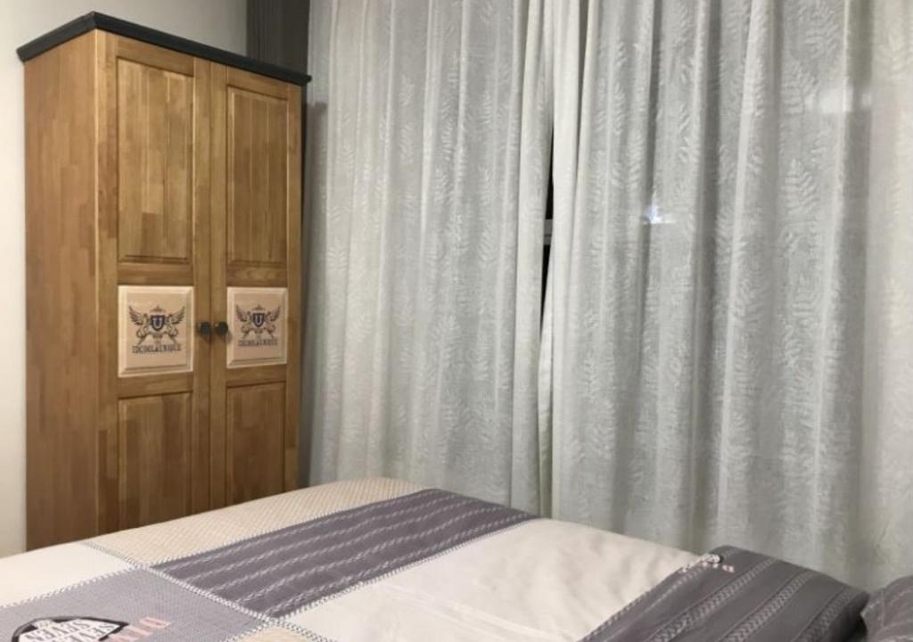 Postel nebo postele na pokoji v ubytování Boxianyuan Three-Bedroom Apartment
