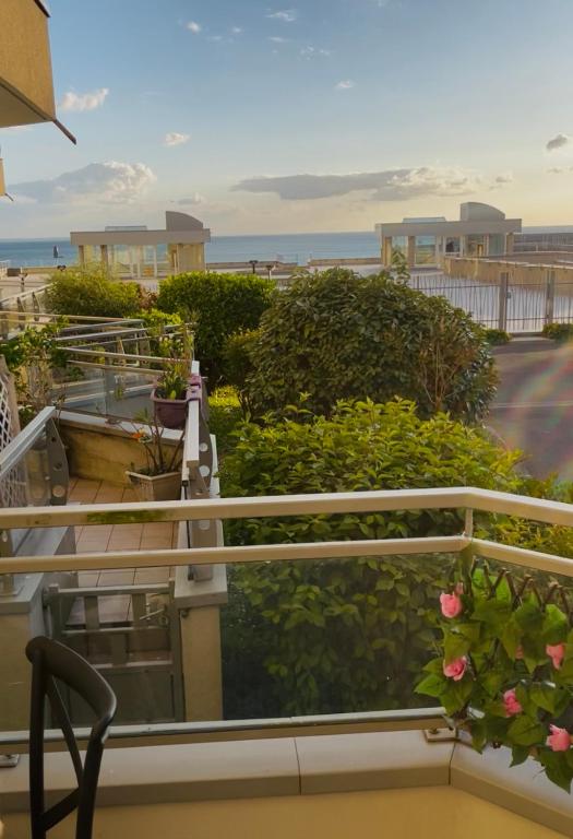 d'un balcon avec des plantes et l'océan en arrière-plan. dans l'établissement Bulle d amour, à Granville