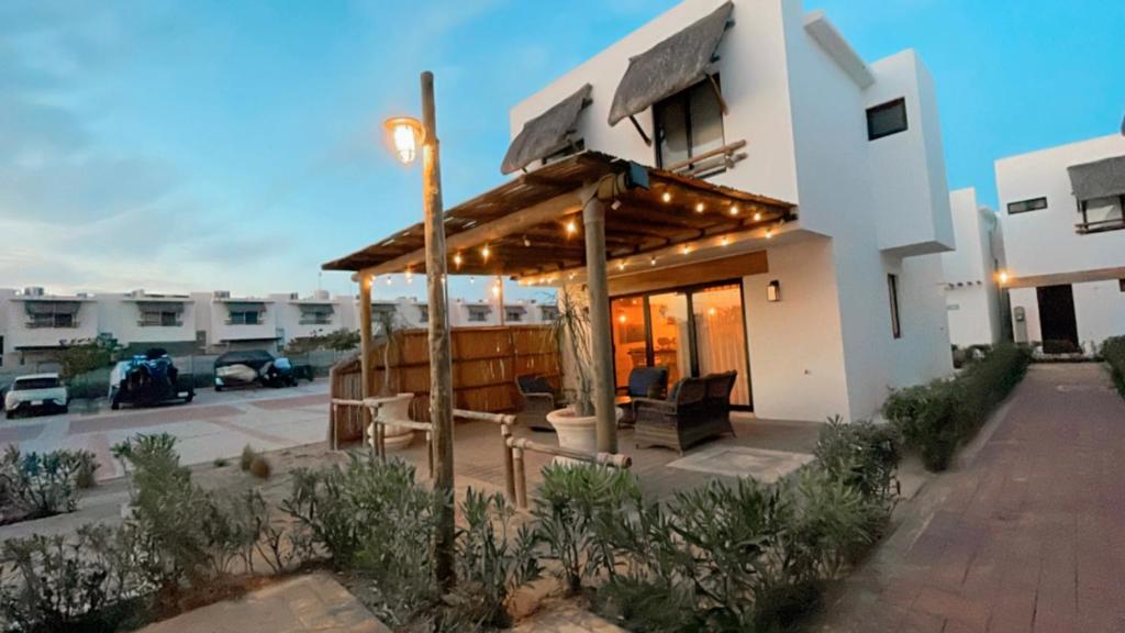 ein Haus mit einem hölzernen Pavillon auf einer Terrasse in der Unterkunft CASA DE PLAYA in Isla de Redo