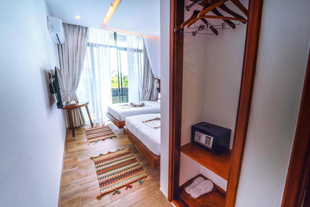 Postel nebo postele na pokoji v ubytování The Mist Hotel Entebbe