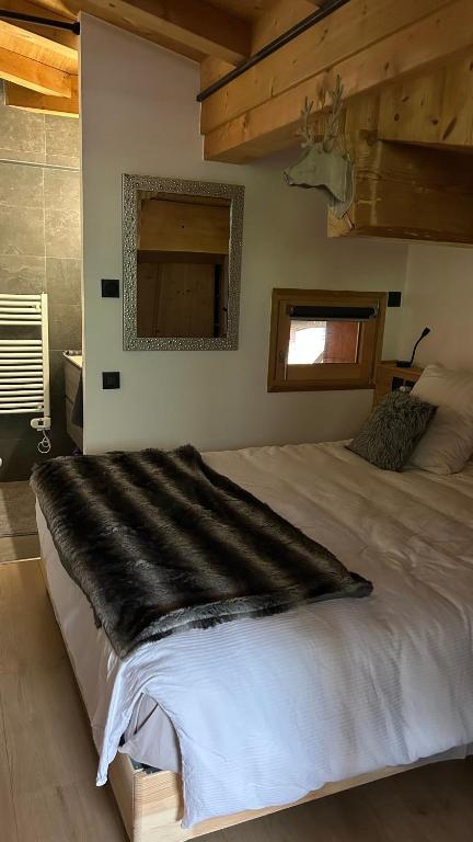 a bedroom with a large bed and a window at Roof top Moutain view direct access Morzine Avoriaz in Montriond
