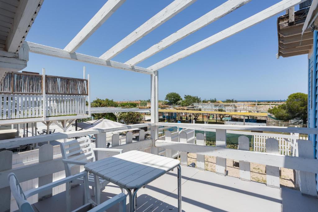 a patio with a table and chairs on a balcony at Oliwood Beach - Gran Hotel in Playa Oliva Nova