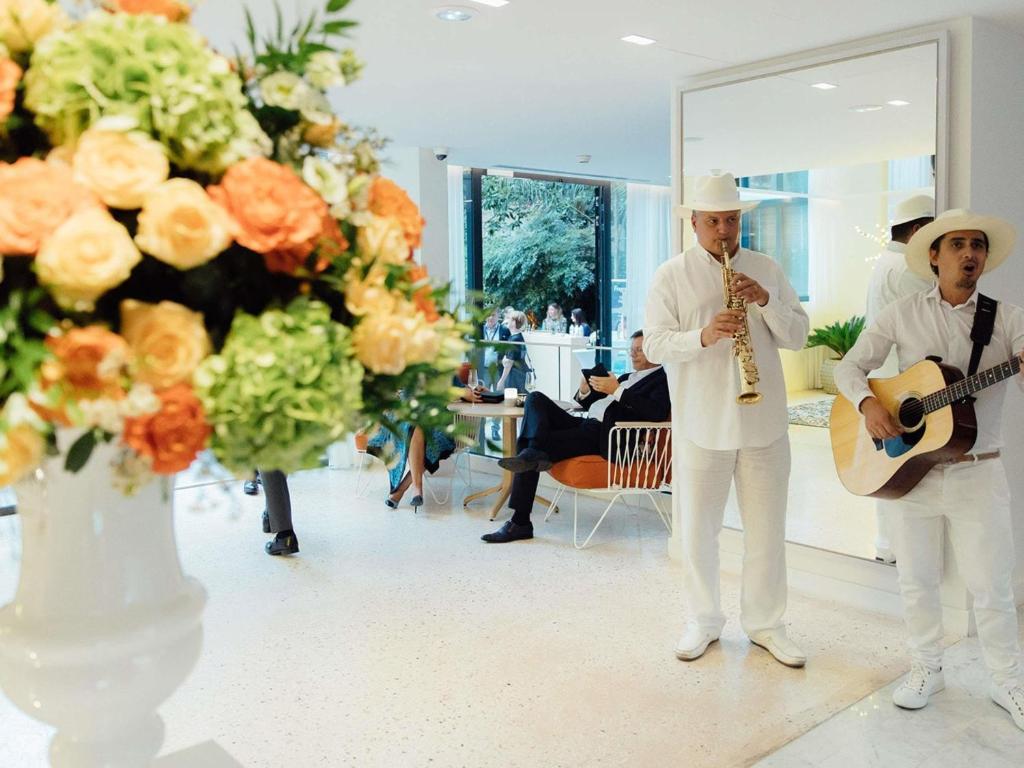 a man playing a guitar and a man playing a guitar at Croisette Beach Hotel Cannes - MGallery Collection in Cannes