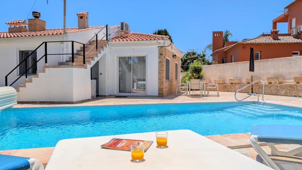 a villa with a swimming pool and a house at VILLA Rübezahl in Benidorm