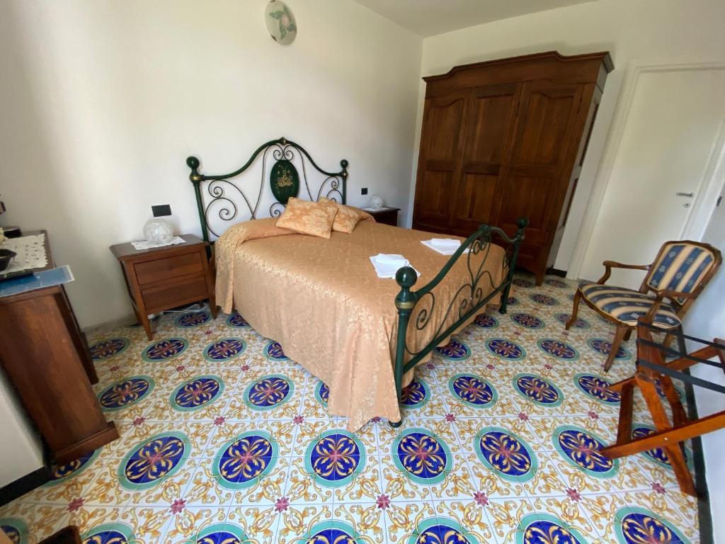 a bedroom with a bed and a chair at Villa Margherita in Levanto