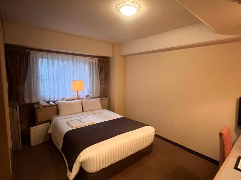 Postel nebo postele na pokoji v ubytování Hotel Listel Shinjuku