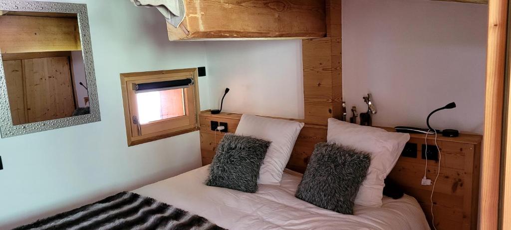 a bedroom with a bed with two pillows on it at Roof top Moutain view direct access Morzine Avoriaz in Montriond