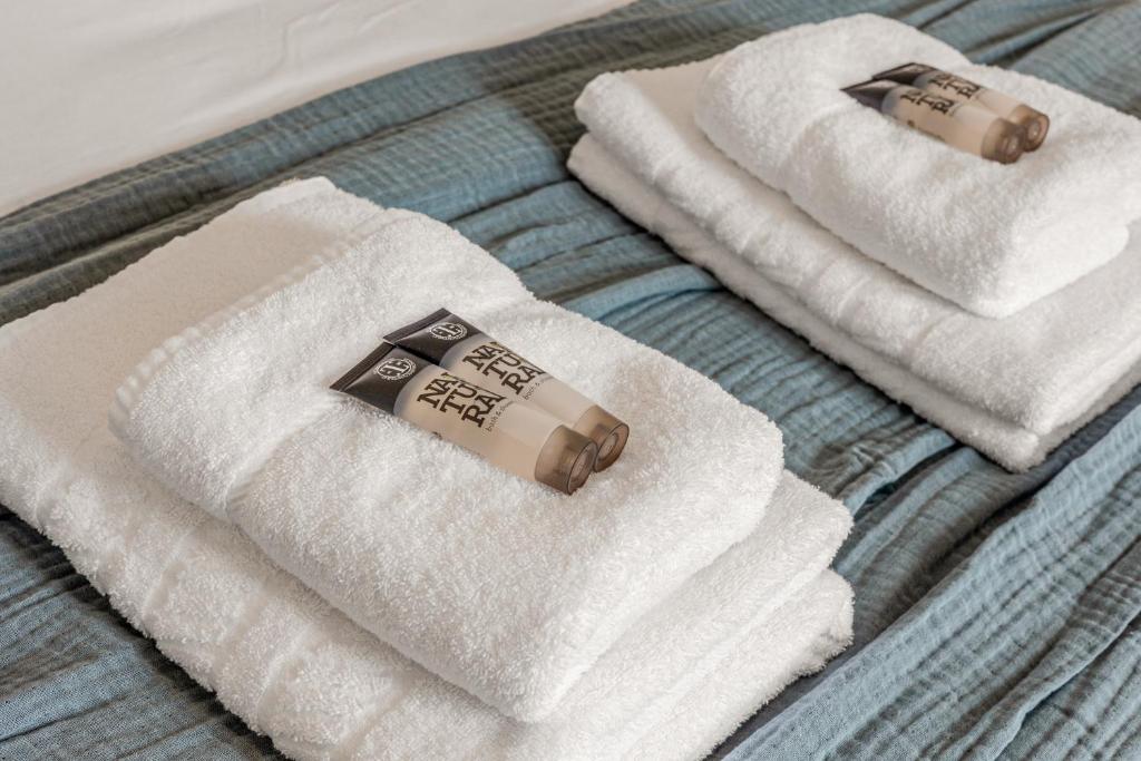 a group of towels sitting on top of a bed at Gorgeous 2BR plus Victorian home with Parking and Garden in London