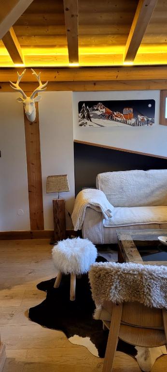 a living room with a bed and a table at Roof top Moutain view direct access Morzine Avoriaz in Montriond