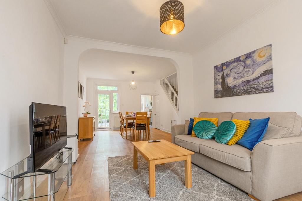 a living room with a couch and a table at Gorgeous 2BR plus Victorian home with Parking and Garden in London