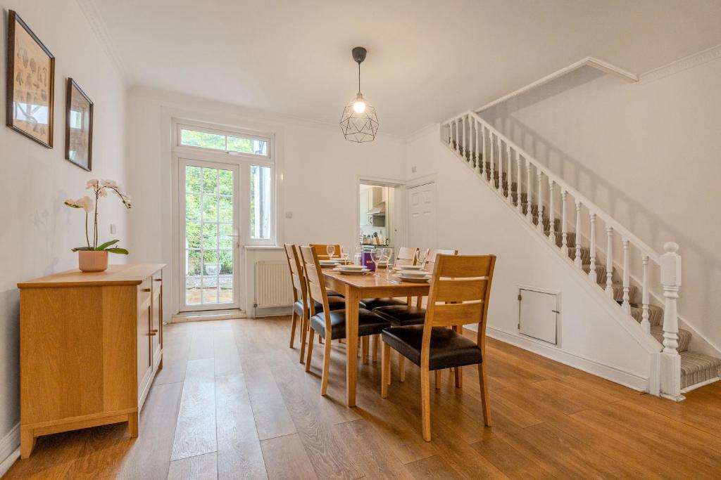 a dining room with a table and chairs at Gorgeous 2BR plus Victorian home with Parking and Garden in London