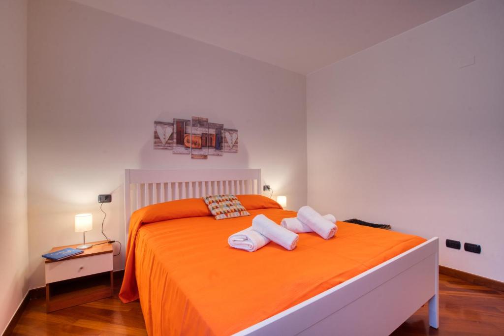 Katil atau katil-katil dalam bilik di CaseOspitali - Casa Oranis, bilocale nuovo con balcone perfetto per famiglie