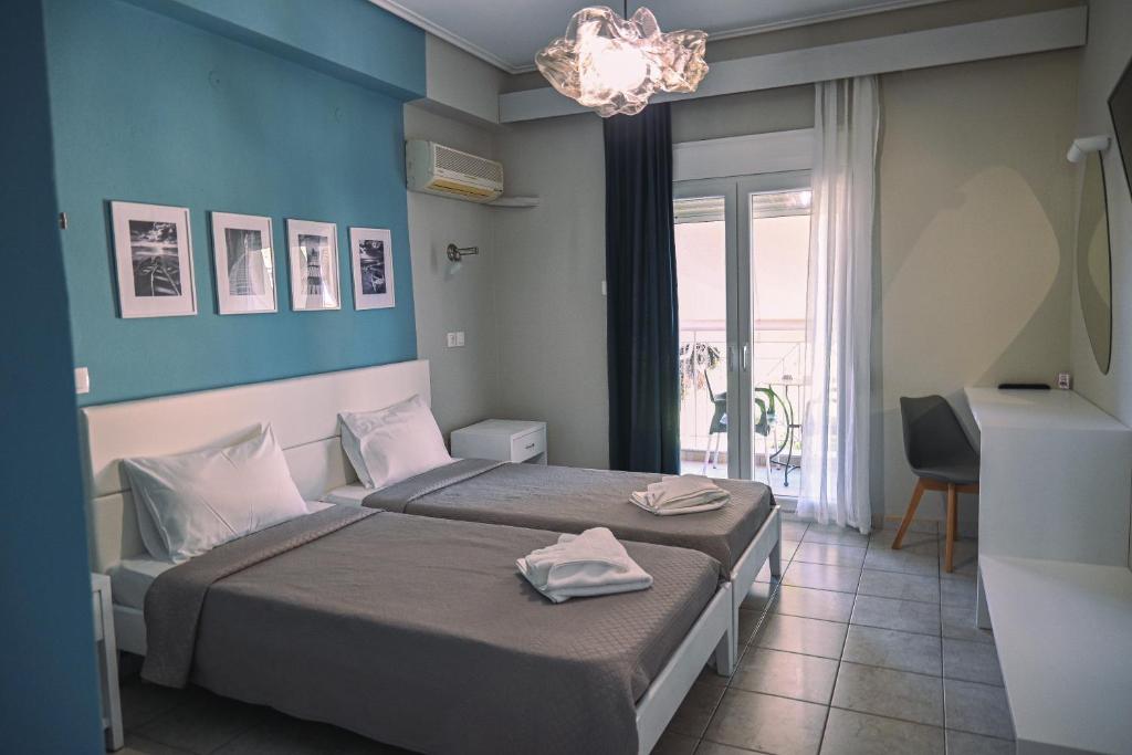 Postel nebo postele na pokoji v ubytování Hotel Kalloni