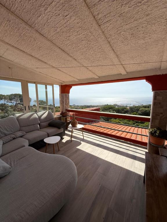 a living room with a couch and a large window at Il Ginepro in Carloforte