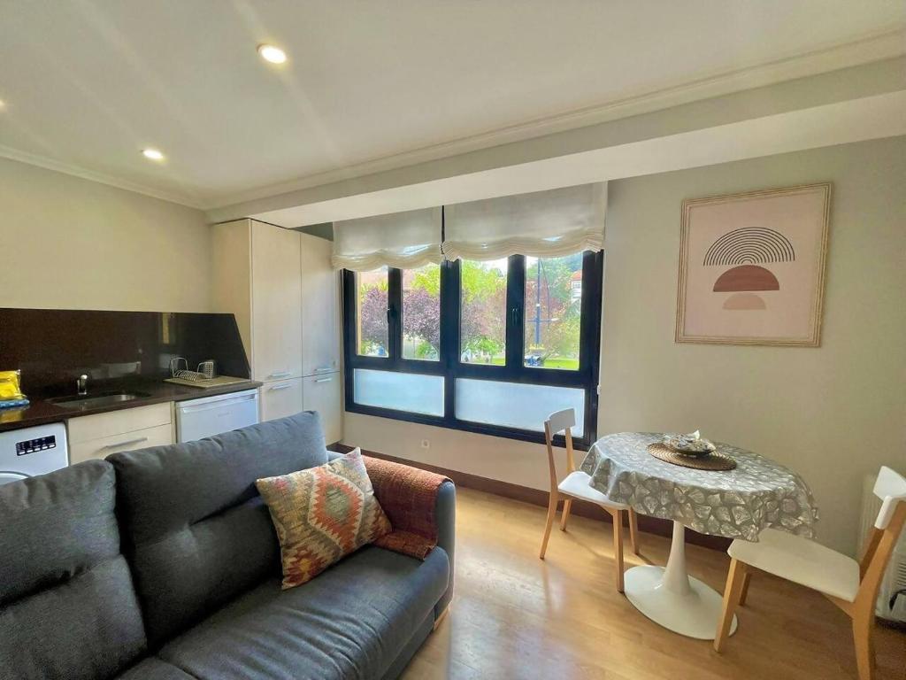 a living room with a couch and a table at Okai Etxea Bermeo, suite en el centro de la villa in Bermeo