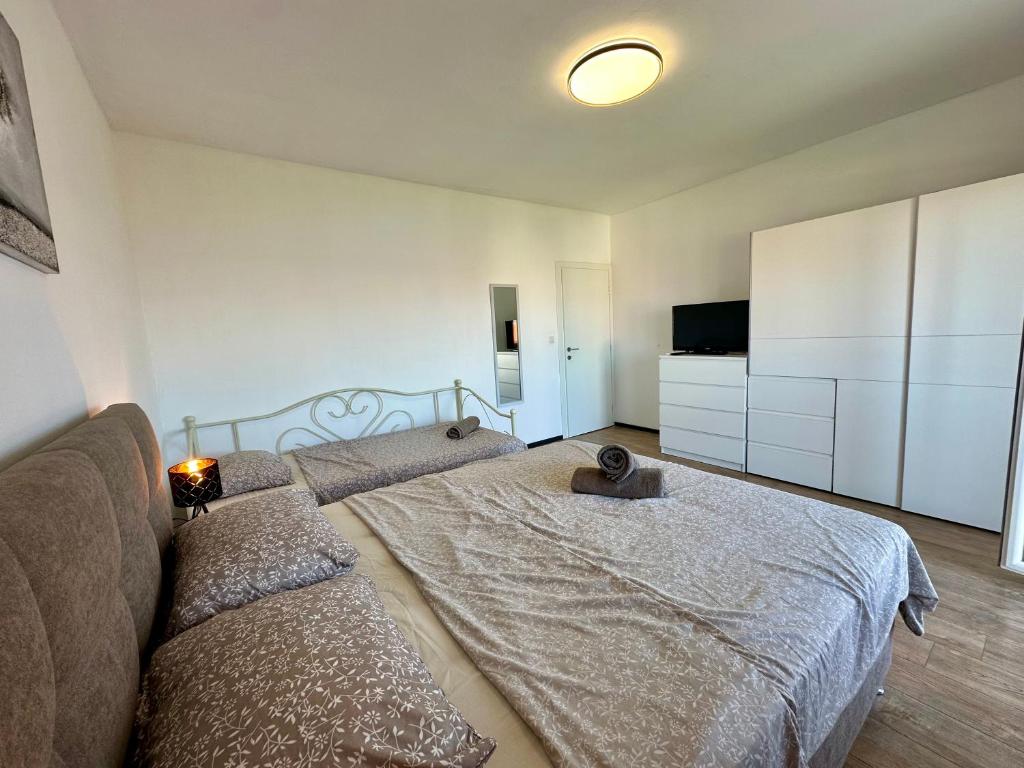 Postel nebo postele na pokoji v ubytování APARTMANI KIKI