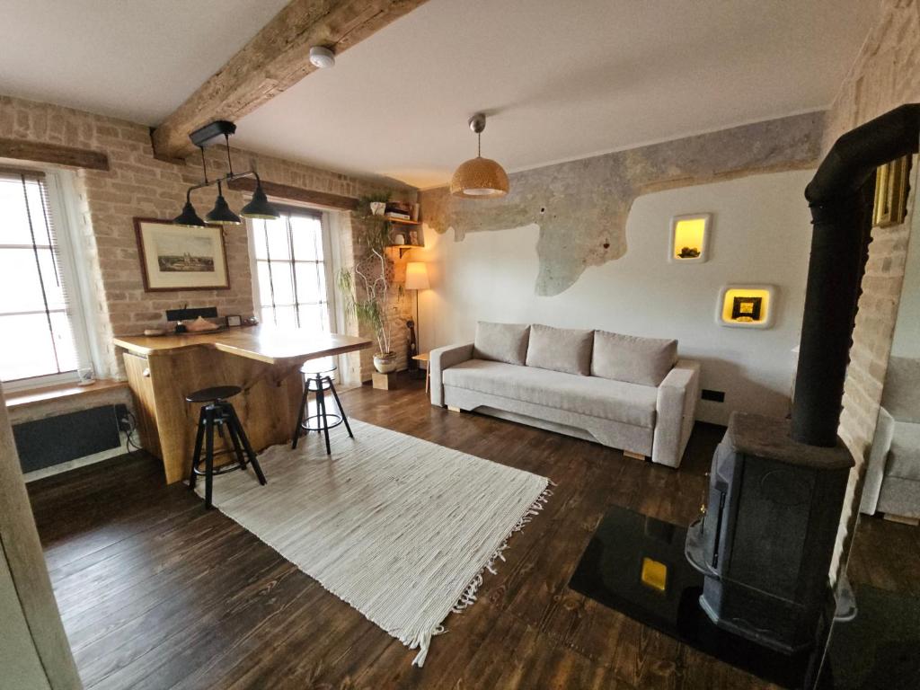 a living room with a couch and a table at Paupio Gertruda in Vilnius