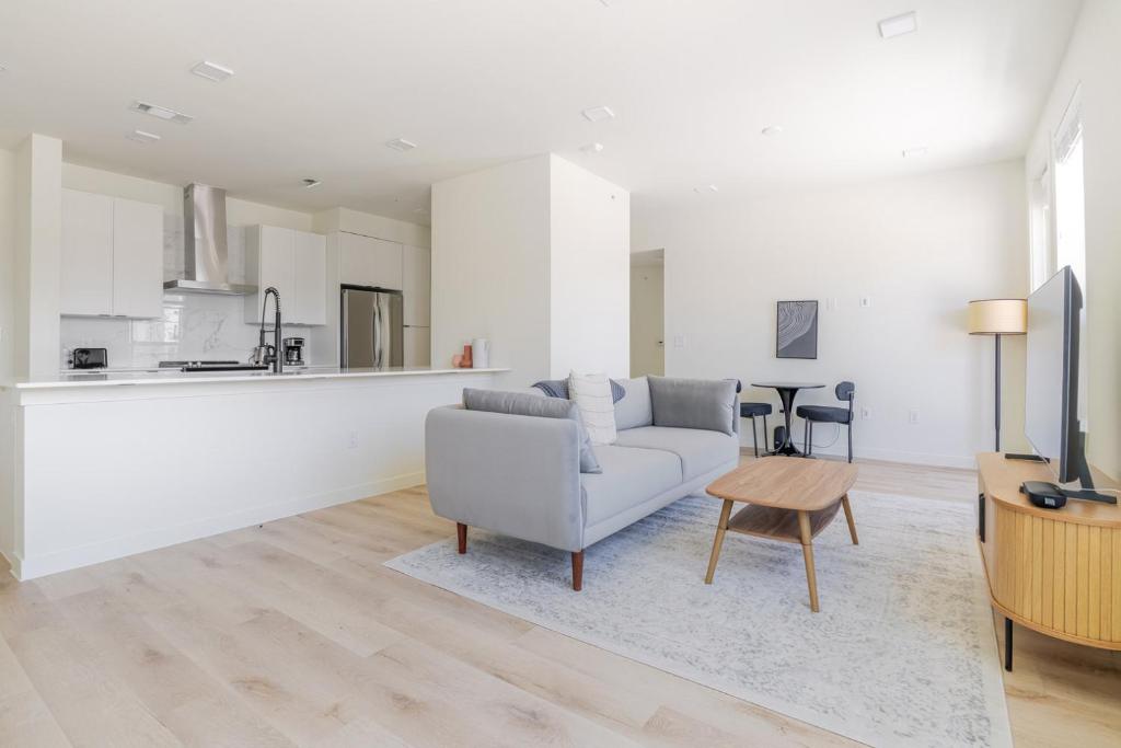 a white living room with a couch and a table at Blueground Round Rock pool nr Brushy Creek ATX-319 in Austin